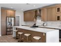 Modern kitchen with a large quartz island, stainless steel appliances, and light wood cabinets at 175 N Brookside St, Chandler, AZ 85225