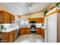 Well-maintained kitchen featuring tile floors, stainless steel appliances, and plenty of cabinet space at 17500 N 85Th Dr, Peoria, AZ 85382