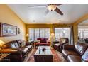 Inviting living room with hardwood furniture, a ceiling fan, and ample natural light from the window at 17500 N 85Th Dr, Peoria, AZ 85382