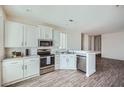 Modern kitchen featuring stainless steel appliances, white cabinets, and a breakfast bar at 2206 S Ellsworth Rd # 129B, Mesa, AZ 85201