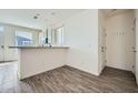 Open kitchen with stainless steel appliances and breakfast bar with view to living area at 2206 S Ellsworth Rd # 129B, Mesa, AZ 85201