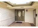 A welcoming front entry with a decorative glass door and sidelights, plus brick and painted wood accents at 2539 E Geneva Dr, Tempe, AZ 85282