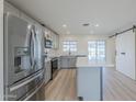 Modern kitchen featuring stainless steel appliances, white countertops, an island, and a sliding barn door at 3220 E Andorra Dr, Phoenix, AZ 85032