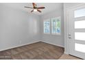 Bright bedroom with neutral carpet, ceiling fan, and double windows allowing natural light at 3504 E Pinto Dr, Gilbert, AZ 85296