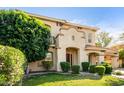 Attractive two-story property with a well-kept lawn, verdant landscaping, and convenient porte-cochère at 3683 E Nolan Dr, Chandler, AZ 85249