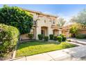 Charming two-story house showcasing lush green grass, mature landscaping, and a porte-cochère at 3683 E Nolan Dr, Chandler, AZ 85249