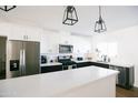 Bright kitchen with stainless steel appliances, white cabinets, dark countertops, and a large island at 4025 N 8Th Ave, Phoenix, AZ 85013