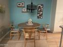 Dining room features a round wooden table with four chairs, overhead chandelier and blue accent wall at 4242 N 27Th St # 2, Phoenix, AZ 85016