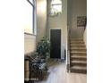 Bright foyer featuring stairs, a black front door, chandelier, large window and decorative plant at 4242 N 27Th St # 2, Phoenix, AZ 85016
