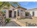 Quaint home exterior featuring a tiled roof, bay window, well-manicured shrubs, and a welcoming front door at 4249 E Nightingale Ln, Gilbert, AZ 85298
