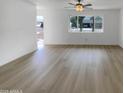 A spacious living room with vinyl floors and a large window providing ample natural light at 492 W 17Th Ave, Apache Junction, AZ 85120