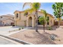 Inviting two-story house featuring desert landscaping, mature trees, and a cozy front entrance at 565 E Rosebud Dr, San Tan Valley, AZ 85143