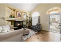Cozy living room featuring a fireplace, high ceilings, and ample natural light at 565 E Rosebud Dr, San Tan Valley, AZ 85143
