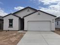 Inviting single story home featuring desert landscaping and a two-car garage at 6071 E Artemis Dr, Florence, AZ 85132