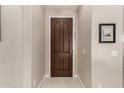 Warm and welcoming entryway featuring a dark wooden door and neutral walls at 690 W Mangrove Rd, Queen Creek, AZ 85140
