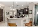 Modern kitchen with granite countertops, stainless steel appliances, and dark cabinetry at 690 W Mangrove Rd, Queen Creek, AZ 85140