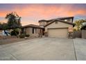 Attractive home exterior with a wide driveway, mature landscaping, and a spacious two-car garage at 7238 W El Cortez Pl, Peoria, AZ 85383