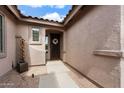 Inviting front entryway with a decorative wreath and concrete pathway amidst a desert landscape, enhancing curb appeal at 7554 E Globemallow Ln, Gold Canyon, AZ 85118
