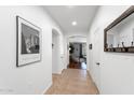 Bright hallway featuring neutral tile flooring, access to multiple rooms, and stylish decor at 7554 E Globemallow Ln, Gold Canyon, AZ 85118