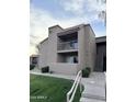 Building exterior featuring balconies, green space and exterior stairs at 8260 E Arabian Trl # 275, Scottsdale, AZ 85258
