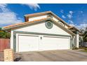 View of the three-car garage of this home with a red tile roof at 844 W Sherri Dr, Gilbert, AZ 85233