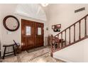 Spacious foyer with double doors, a staircase, and decorative tile flooring at 844 W Sherri Dr, Gilbert, AZ 85233