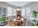 Cozy dining area featuring a round wooden table, four chairs, and natural light at 9364 W Cordes Rd, Tolleson, AZ 85353