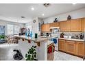 Bright eat-in kitchen with light wood cabinets, white appliances, and tile flooring at 9364 W Cordes Rd, Tolleson, AZ 85353