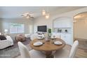 Cozy living space featuring a modern ceiling fan, plush seating, and stylish dining area at 12333 W Marshall Ave, Litchfield Park, AZ 85340