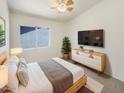 Bright bedroom featuring a ceiling fan and window, with sleek modern furniture, and a neutral decor at 1360 E Washington Ave, Gilbert, AZ 85234