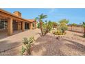 Large back yard featuring rock ground cover, desert landscaping, and covered porch at 15834 W Avalon Dr, Goodyear, AZ 85395