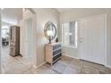 Bright entryway with tile floors, natural light, and views into the kitchen at 15834 W Avalon Dr, Goodyear, AZ 85395