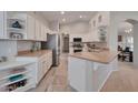 Bright kitchen features white cabinetry, modern appliances, and seamless flow to dining area at 15834 W Avalon Dr, Goodyear, AZ 85395