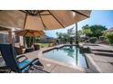 Inviting backyard with pool, spa, desert landscaping, covered patio, and outdoor seating at 1620 W Nighthawk Way, Phoenix, AZ 85045