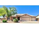 Beautiful home featuring a three-car garage, desert landscaping, and a well-maintained tile roof at 1624 E Marigold St, Casa Grande, AZ 85122