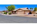 Well maintained home with a three-car garage, tile roof, and low maintenance landscaping at 1624 E Marigold St, Casa Grande, AZ 85122