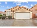 A front view of a one-story house with a terra cotta roof and a two-car garage at 16823 S 8Th St, Phoenix, AZ 85048