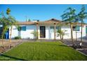 Beautifully landscaped front yard featuring a well maintained yard, complemented by mature trees and desert landscaping at 2019 W Wayland Rd, Phoenix, AZ 85041