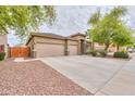 Wide driveway, desert landscaping, and well-maintained exterior enhance this home's curb appeal at 20583 N Ryans Trl, Maricopa, AZ 85138