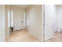 Inviting foyer featuring neutral tile flooring, a decorative front door, and plenty of natural light at 20583 N Ryans Trl, Maricopa, AZ 85138