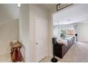 Entryway with access to the living room featuring a leather sofa and a fan at 30683 W Amelia Ave, Buckeye, AZ 85396