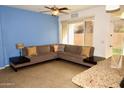 Comfortable living area with tile flooring, ceiling fan, and neutral blue walls at 3435 E Amber Ln, Gilbert, AZ 85296