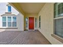 Covered front entrance with a striking red door and brick-paved walkway at 3842 E Fountain St, Mesa, AZ 85205