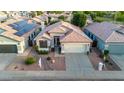 An aerial view of a home featuring a terracotta roof, desert landscaping, and a two-car garage at 3907 E Topeka Dr, Phoenix, AZ 85050