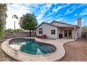 A backyard featuring a private pool surrounded by a concrete patio and desert landscaping at 3907 E Topeka Dr, Phoenix, AZ 85050