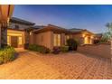 Paver driveway with desert landscaping and a warm-toned exterior at 41424 N Club Pointe Dr, Anthem, AZ 85086