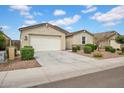 Front view of a well-maintained one story home with a two car garage and low maintenance landscaping at 4148 W Dayflower Dr, San Tan Valley, AZ 85144