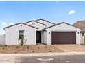Charming single-story home featuring a brick driveway, a two-car garage and neutral colored stucco at 4795 W Hunter Trl, San Tan Valley, AZ 85144
