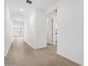 Bright hallway features neutral tile, leading to rooms and other spaces at 4795 W Hunter Trl, San Tan Valley, AZ 85144