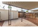 Backyard covered patio with metal beams and posts, storage shed, and fenced yard at 6411 S El Camino Dr, Tempe, AZ 85283